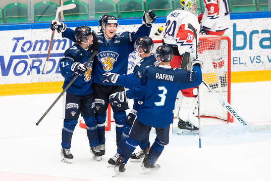 Olli Nikupeteri of Finland celebrates with teammates