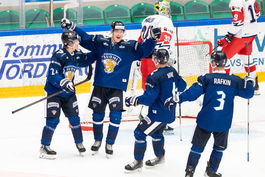 Olli Nikupeteri of Finland celebrates with teammates