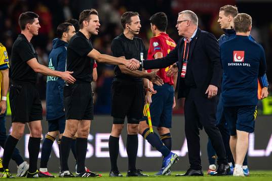Referee Felix Brych and head coach Janne Andersson of Sweden