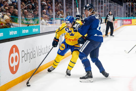 Pontus Holmberg of Sweden and Tony Sund #6 of Finland