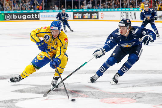 Joakim Nygård of Sweden and Tony Sund #6 of Finland