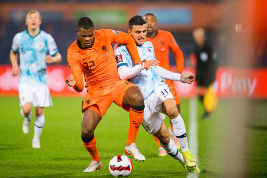 Denzel Dumfries of Netherlands and Mohamed Elyounoussi of