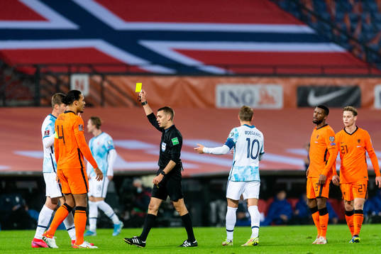 Alexander Sørloth of Norway is shown a yellow card by