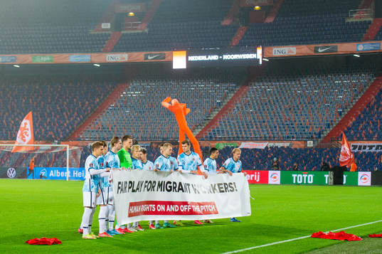 Players of Norway pose with a banner
