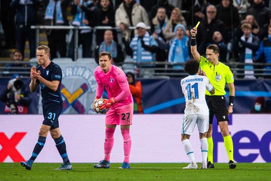 Claudinho of Zenit receives a warning from Referee Andris