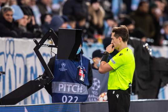 Referee Andris Treimanis checks