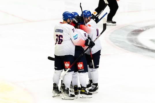 Luca Tosto of Adler Mannheim celebrate with teammates