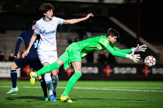 Isak Bjerkebo of Malmö FF against goalkeeper Georgii