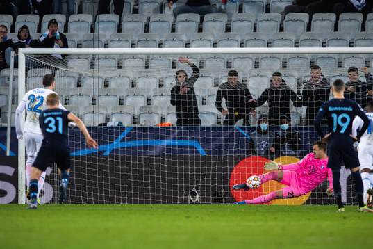 Goalkeeper Johan Dahlin of Malmö FF saves a penalty from