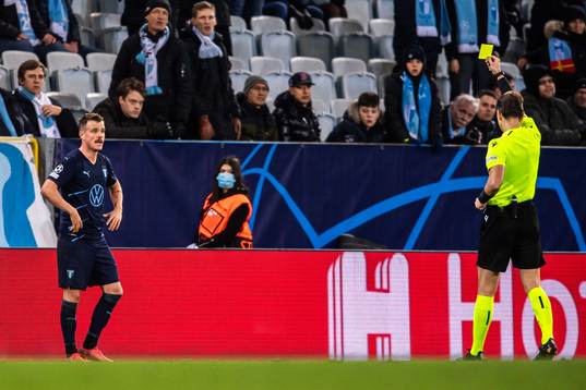 Eric Larsson of Malmö FF receives a yellow card from
