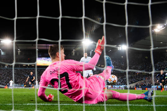 Goalkeeper Johan Dahlin of Malmö FF saves a penalty from