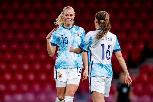 Guro Reiten of Norway celebrates with teammate Guro