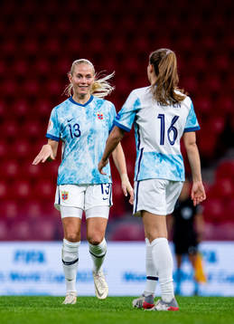 Guro Reiten of Norway celebrates with teammate Guro