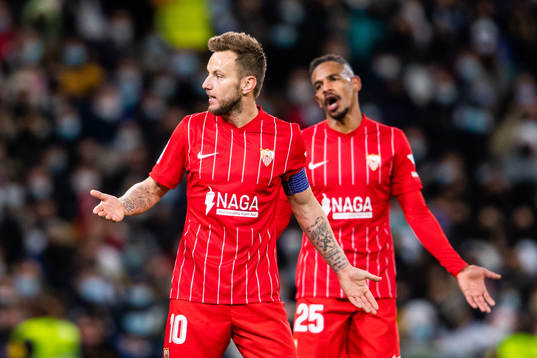 Ivan Rakitic and Fernando of Sevilla react