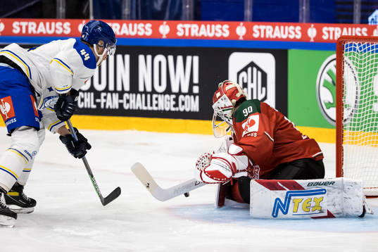 Carter Ashton  of Leksand and goalkeeper Matthew Tomkins of