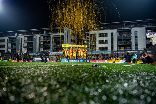Players and staff of Bodø/Glimt celebrate with the trophy