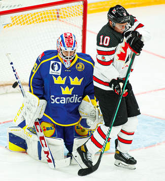 Adam Reideborn of Sweden vies against Jordan Weal of Canada