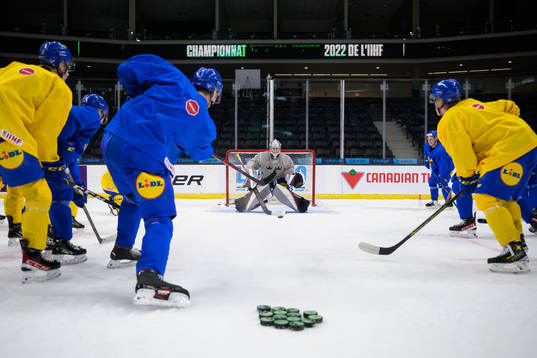 Helge Grans shoots against goaltender Jesper Vikman of the