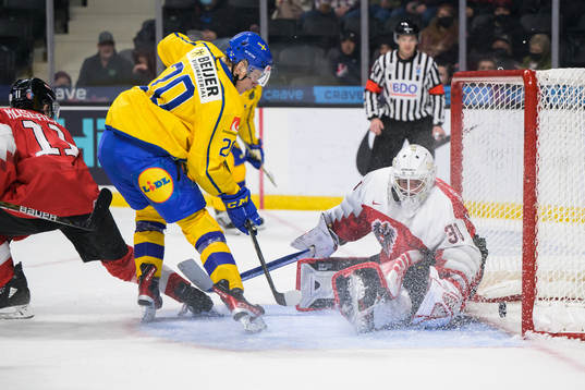 Albert Sjöberg of Sweden scores 2-0 behind goaltender