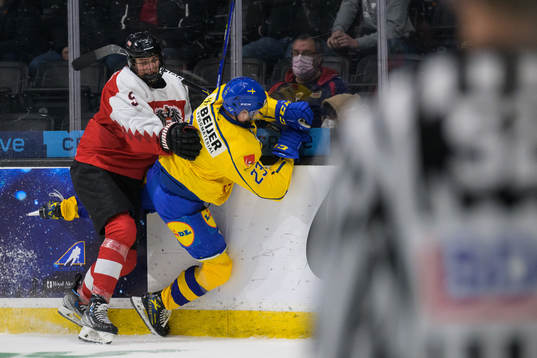 David Reinbacher of Austria tackles Isak Rosén of Sweden