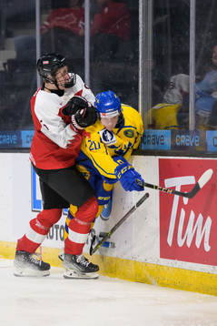 David Reinbacher of Austria tackles Albert Sjöberg of