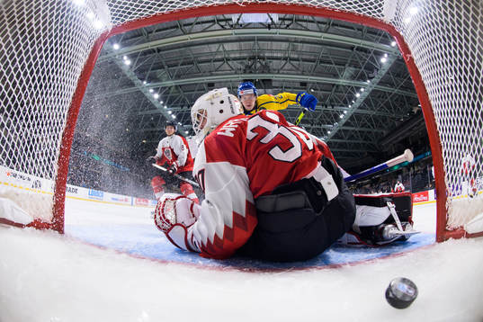 Albert Sjöberg of Sweden scores 2-0 behind goaltender