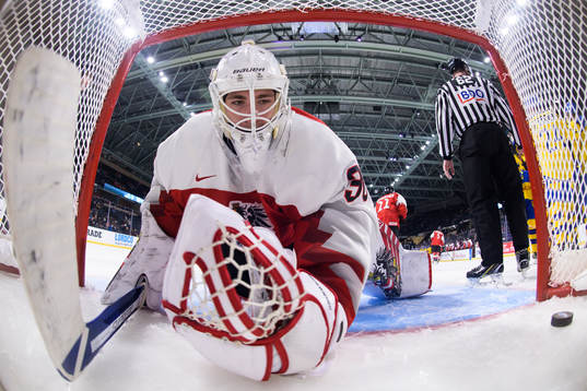 Goaltender Sebastian Wraneschitz of Austria looks dejected