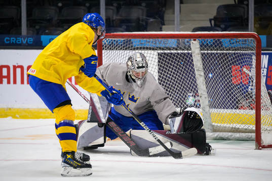 Åke Stakkestad shoots at goaltender Jesper Vikman of