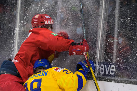 Dmitri Zlodeyev of Russia tackles Oskar Magnusson of Sweden