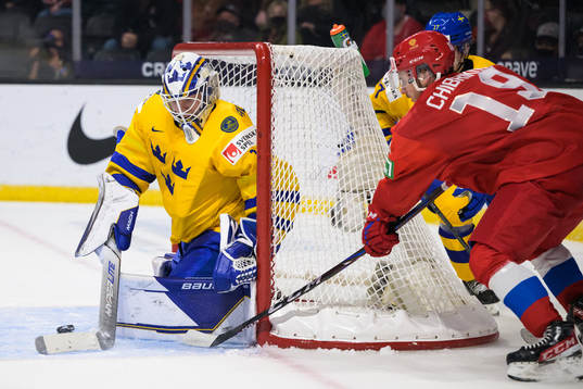 Goaltender Jesper Wallstedt of Sweden is being challenged