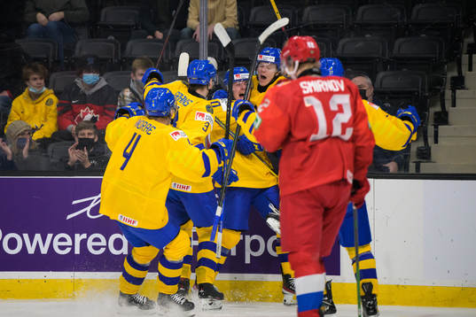 Alexander Holtz of Sweden celebrates with teammates