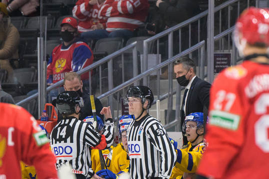 One of the referees explains the decision of the 3-4 goal