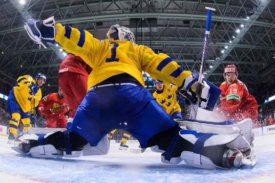 Goaltender Jesper Wallstedt of Sweden is being challenged