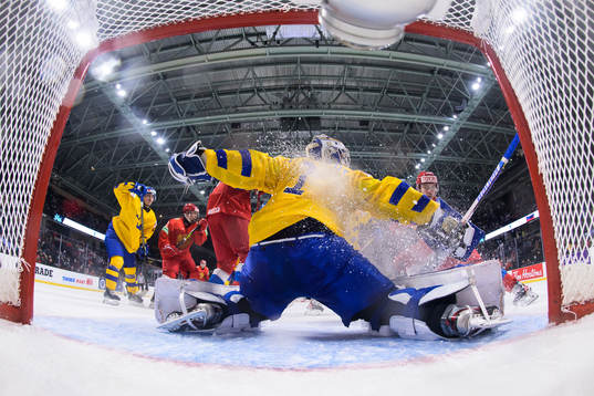 Goaltender Jesper Wallstedt of Sweden is being challenged