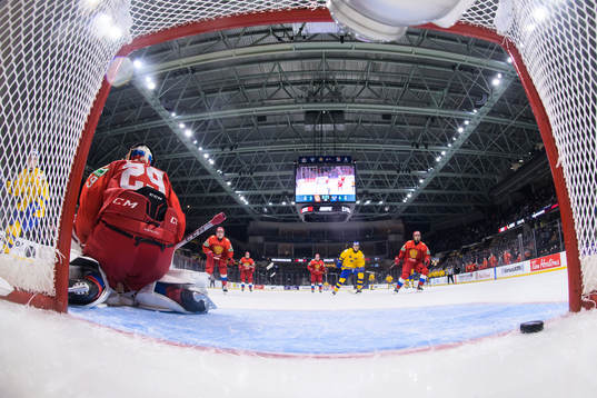 Theodor Niederbach of Sweden scores 3-5 behind goaltender