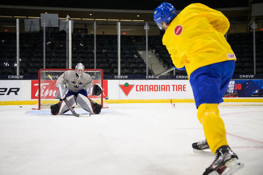 Goaltender Jesper Vikman and Måns Forsfjäll of Sweden at