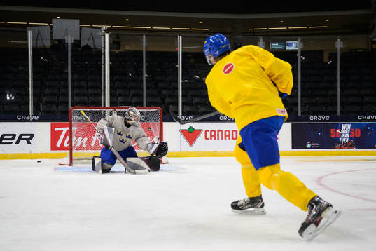 Goaltender Jesper Vikman and Måns Forsfjäll of Sweden at