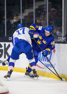 Simon Nemec of Slovakia tackles Elliot Ekmark of Sweden