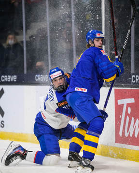 Juraj Slafkovsky of Slovakia and Leo Lööf of Sweden