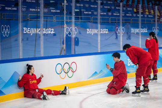 Players of China women’s ice hockey team take pictures of