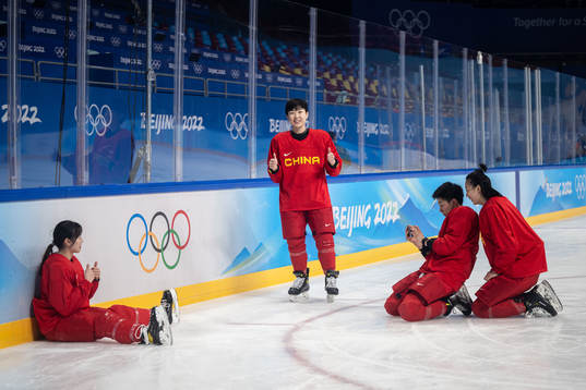 Players of China women’s ice hockey team take pictures of