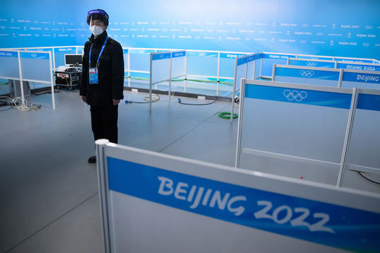 A man with personal protective gear stands guard in the