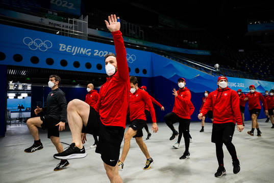 Players of the Swiss national ice hockey team warm up next