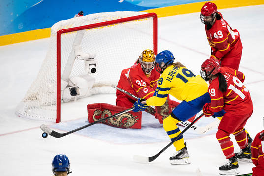 Sara Hjalmarsson of Sweden and goaltender Jiaying Zhou of