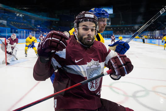 Janis Jaks of Latvia is being tackled by Joakim Nordström