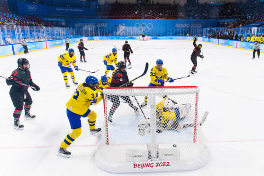 Jamie Lee Rattray of Canada scores a goal behind goaltender