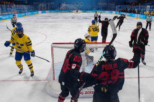Players of Canada celebrates while goaltender Emma