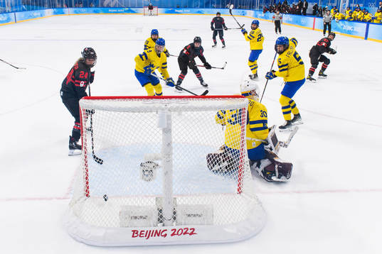 Natalie Spooner of Canada scores a goal behind goaltender