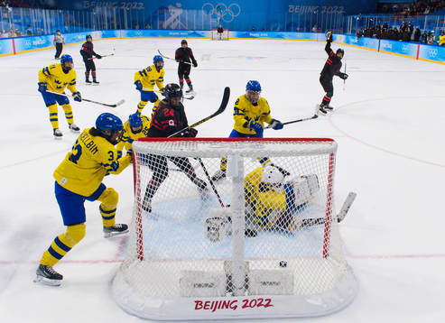 Jamie Lee Rattray of Canada scores a goal behind goaltender