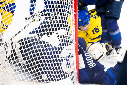 Marcus Krüger of Sweden and goaltender Jussi Olkinoura of